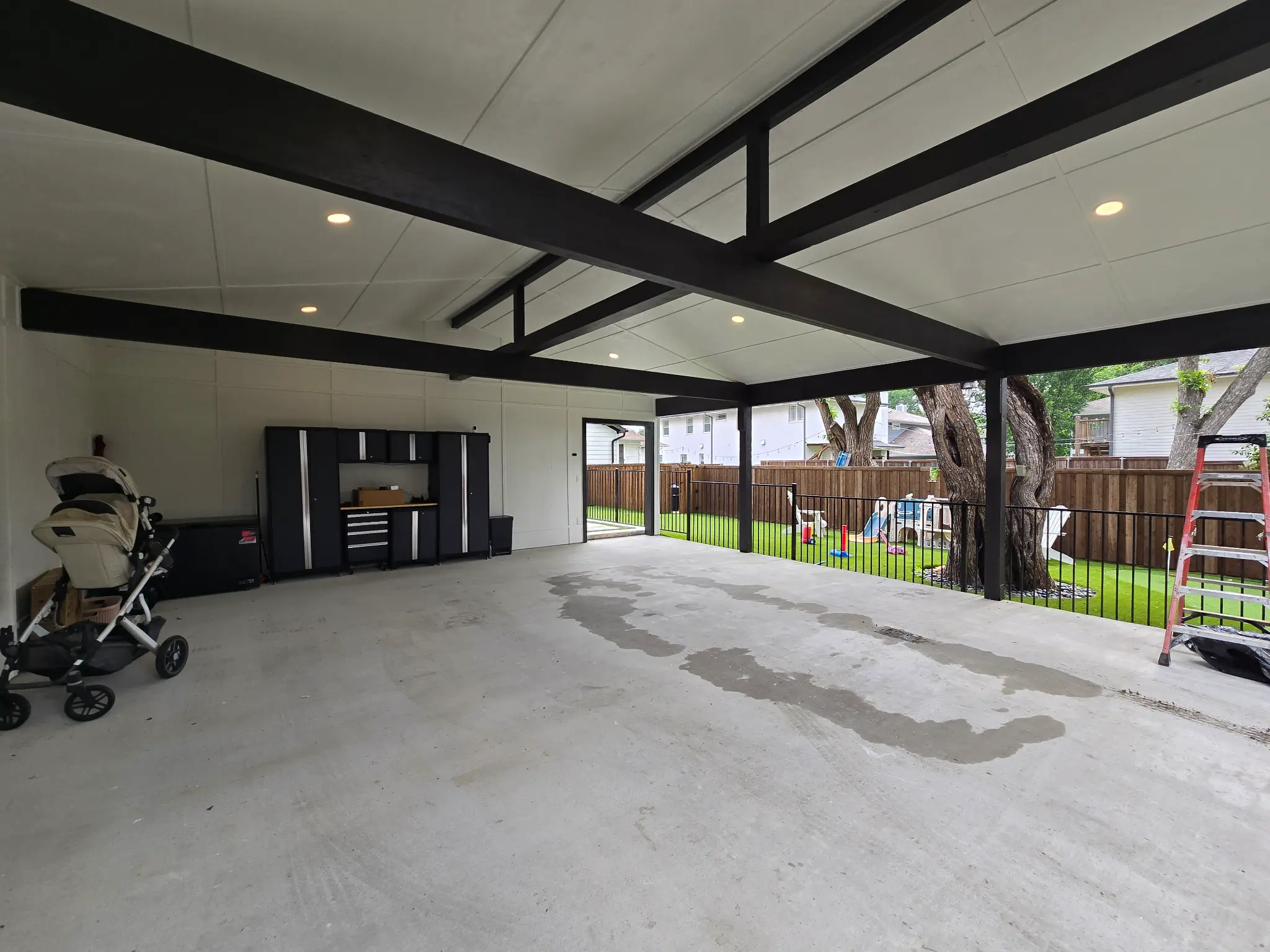 Completed 20 by 29 foot alley-access carport with black steel framing in Dallas, Texas